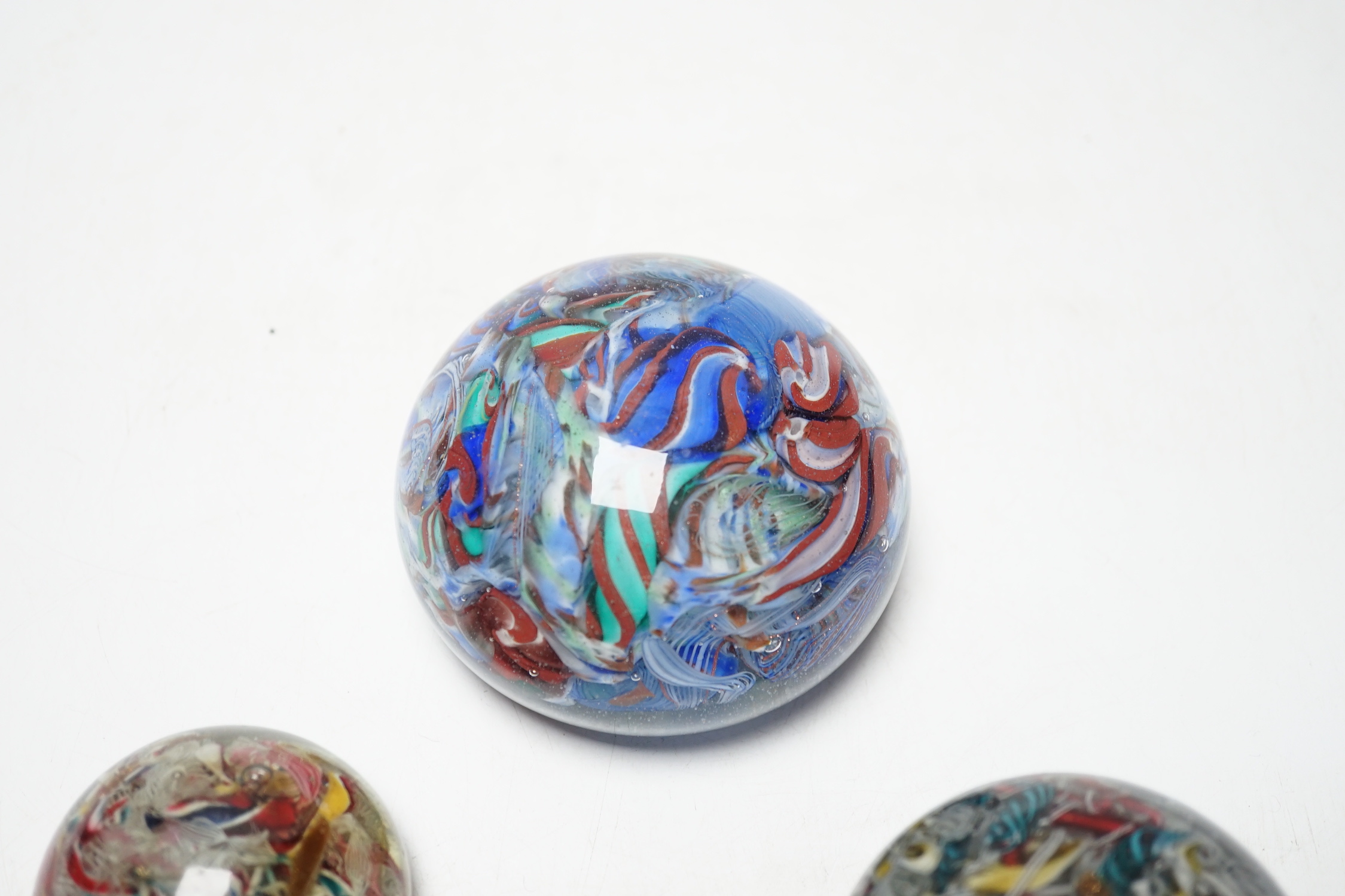 Three 19th century Venetian scrambled glass paperweights, largest 8.5cm